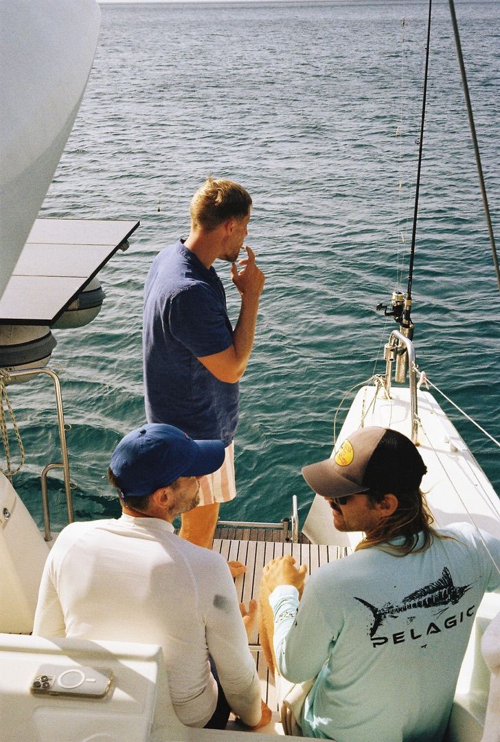 Crew chatting on the bow in daylight