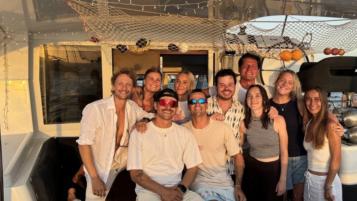 A crew group photo at golden hour