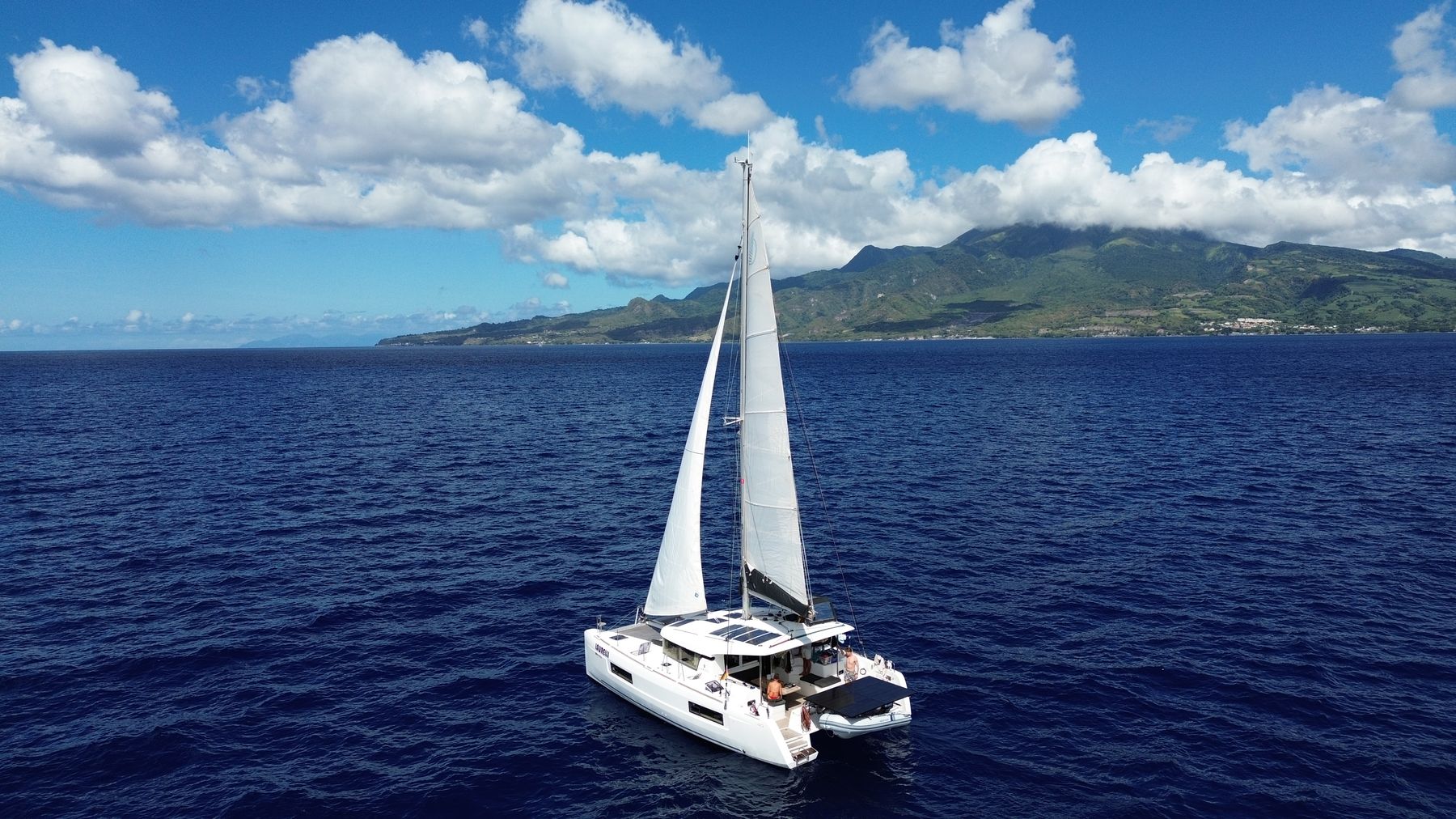 Laurelli sailing along a tropical coastline
