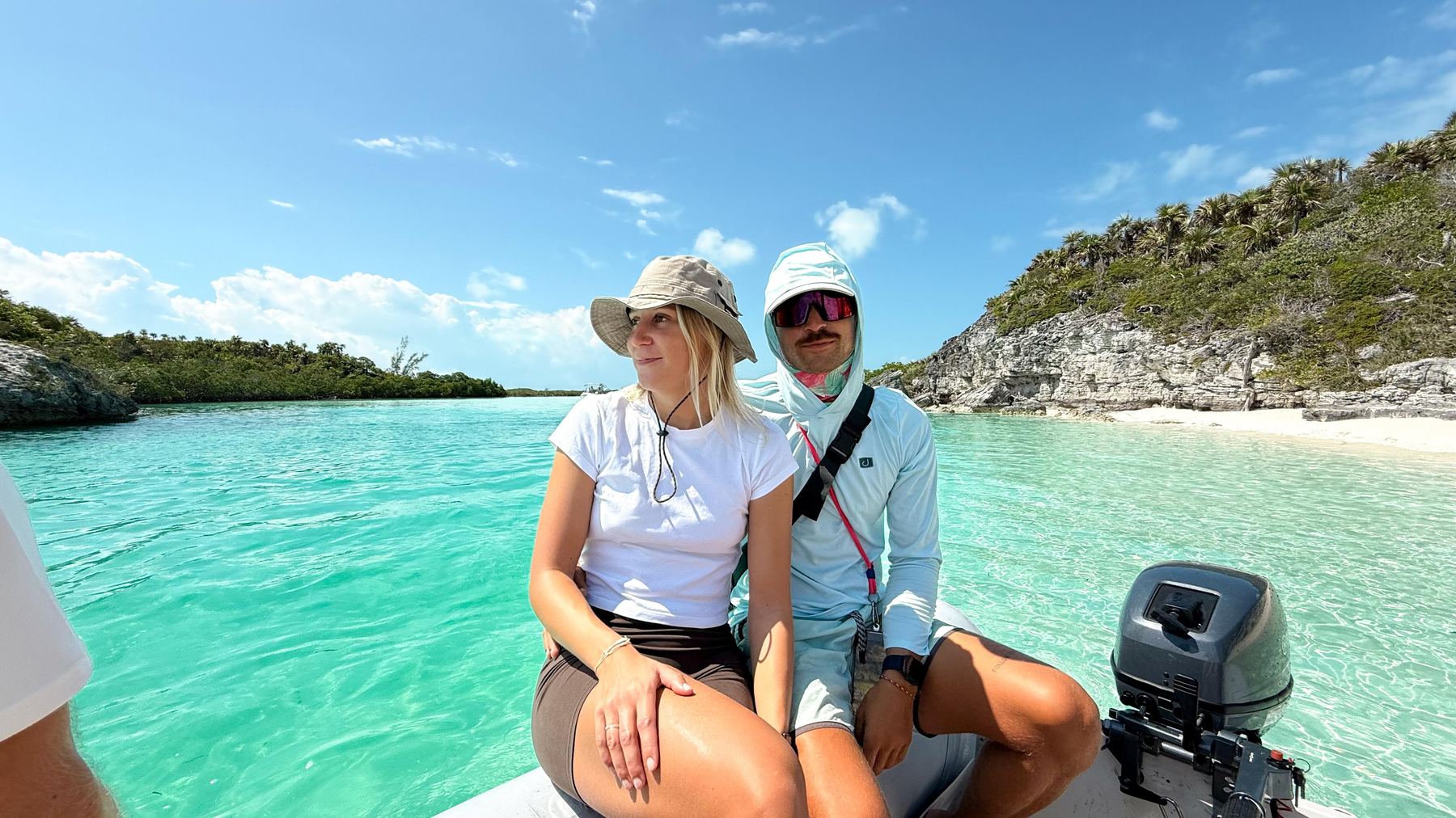 Felix and Ella on a dinghy in turquoise water
