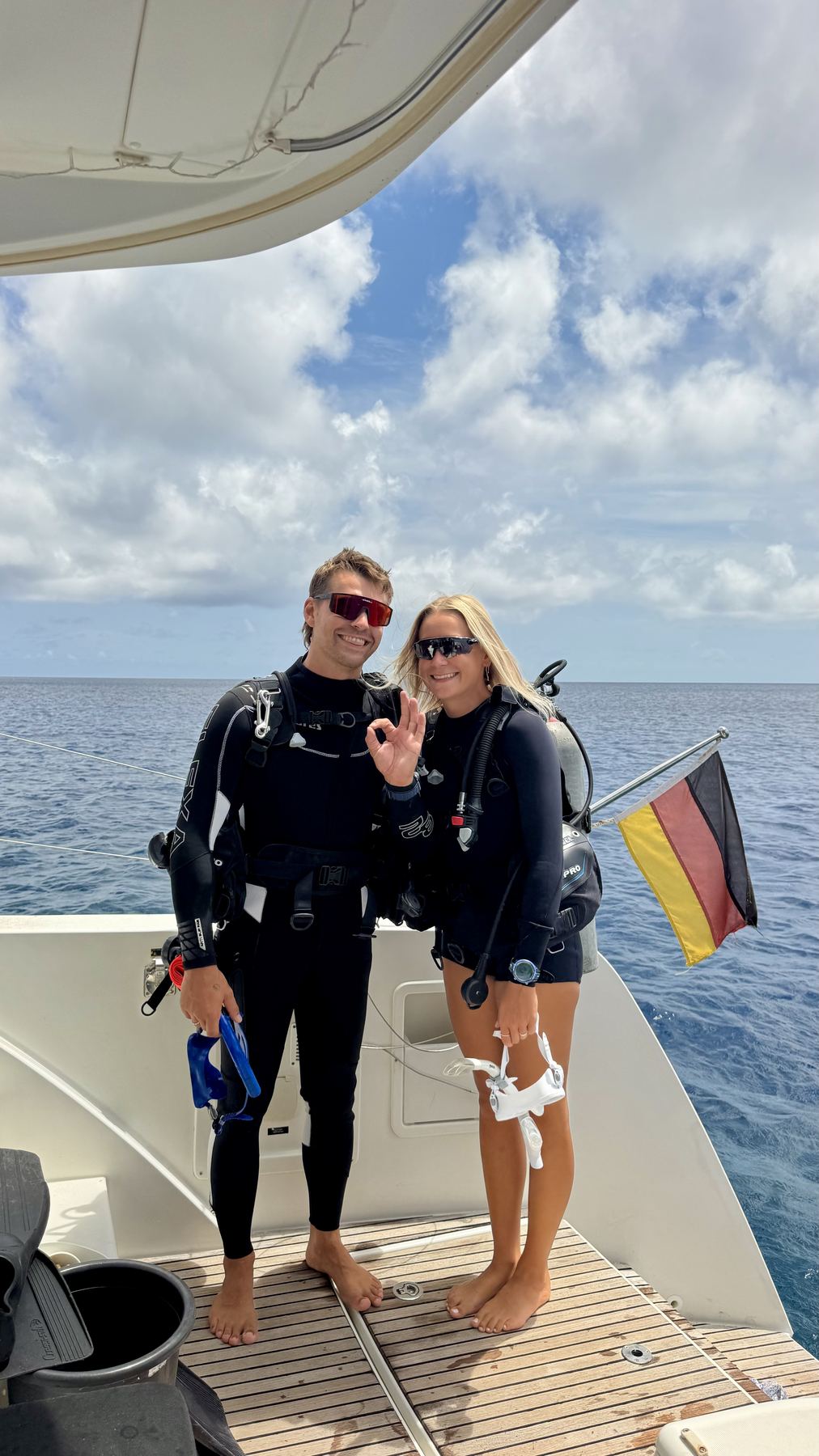 Felix and Ella in scuba gear on deck